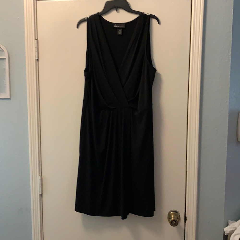 Sleeveless black dress with draping